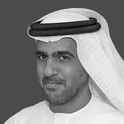 Black and white portrait of H.E. Rashid Saeed Al Ameri, Under-Secretary for Government Coordination Sector at the Ministry of Presidential Affairs.